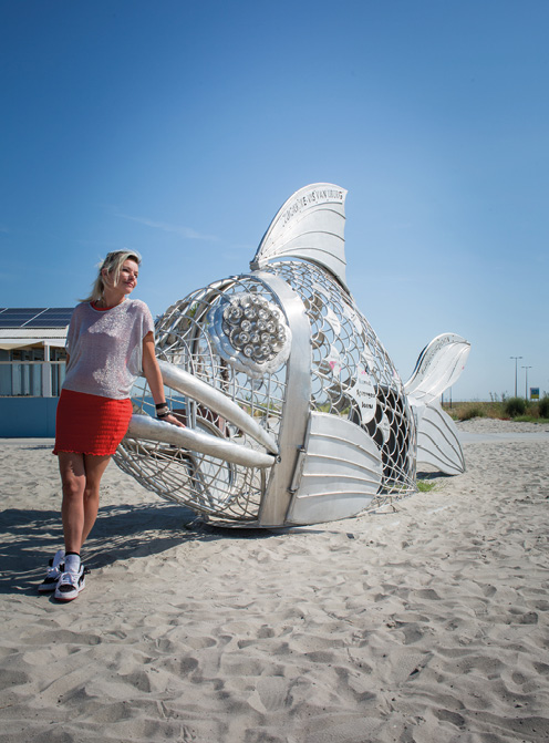 Jikker Reiber staat bij kunstwerk de Zuiderzeevis dat mensen bewust moet maken van plastic afval op het strand © Sandra Hoogeboom